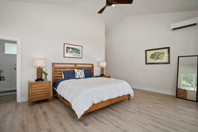 a bedroom with a bed and a lamp on table