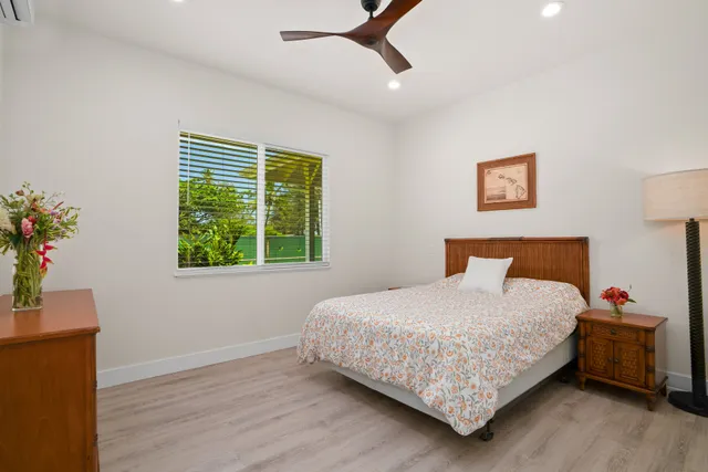 a bedroom with a bed dresser and a window