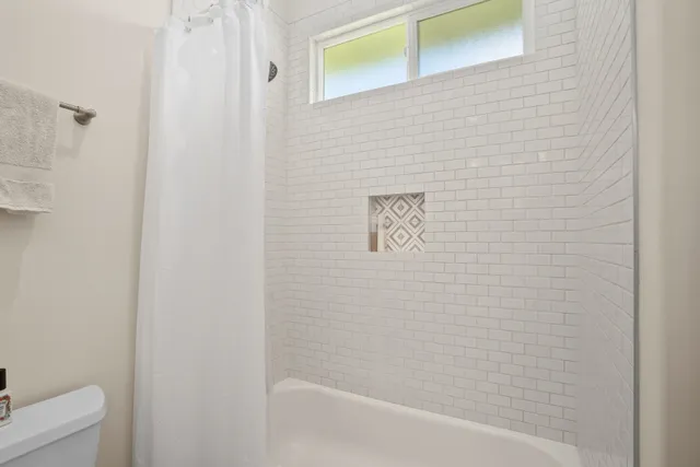 a bathroom with a shower and a toilet