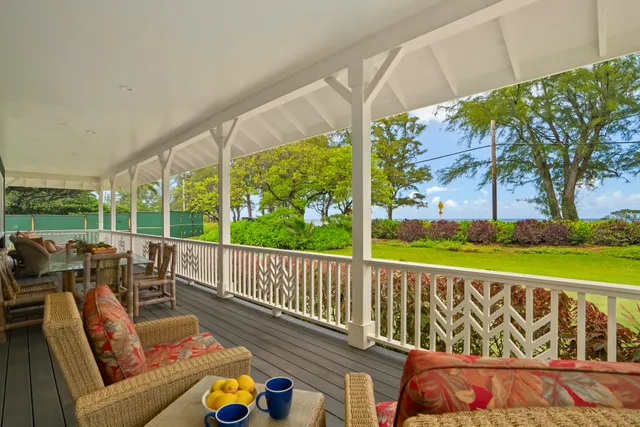 a balcony with furniture and garden view