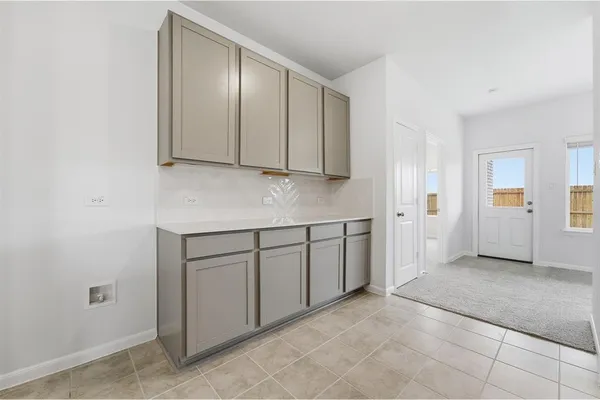 a kitchen with granite countertop a sink and cabinets