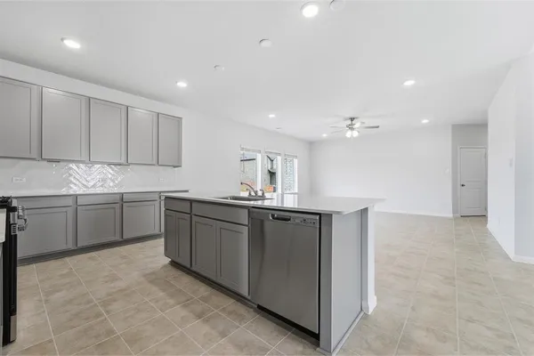a large kitchen with stainless steel appliances lots of counter top space