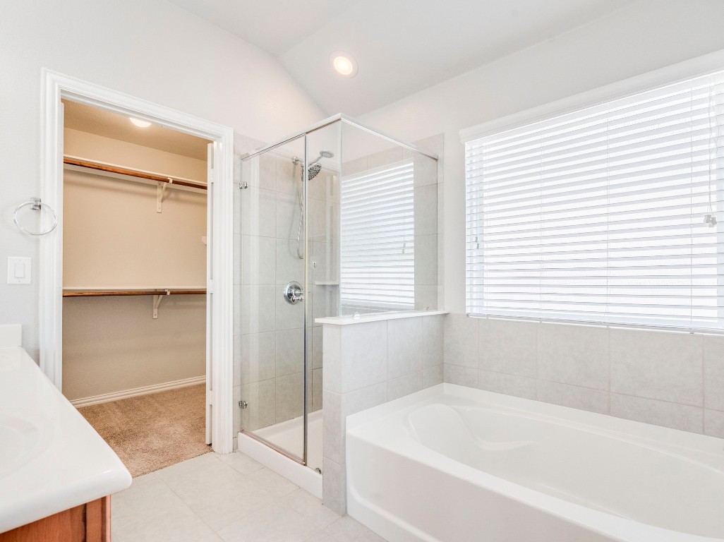 225 Razzmatazz Trail Buda, TX 78610 - Photo 17 of 28 a white bath tub sitting next to a shower