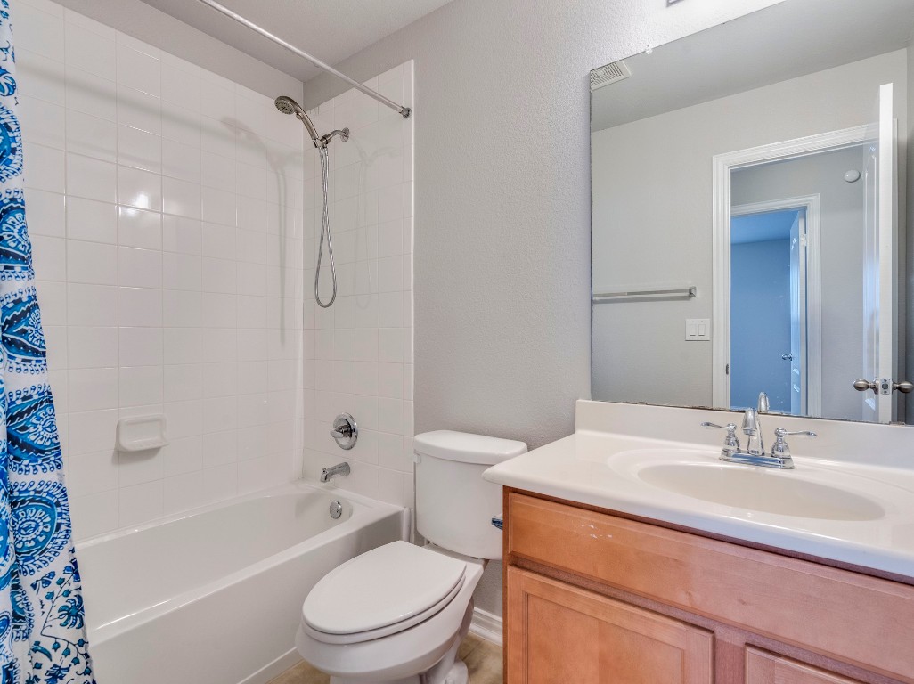 225 Razzmatazz Trail Buda, TX 78610 - Photo 24 of 28 a bathroom with a sink toilet vanity and shower