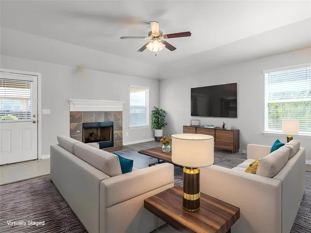 a living room with furniture and a fireplace