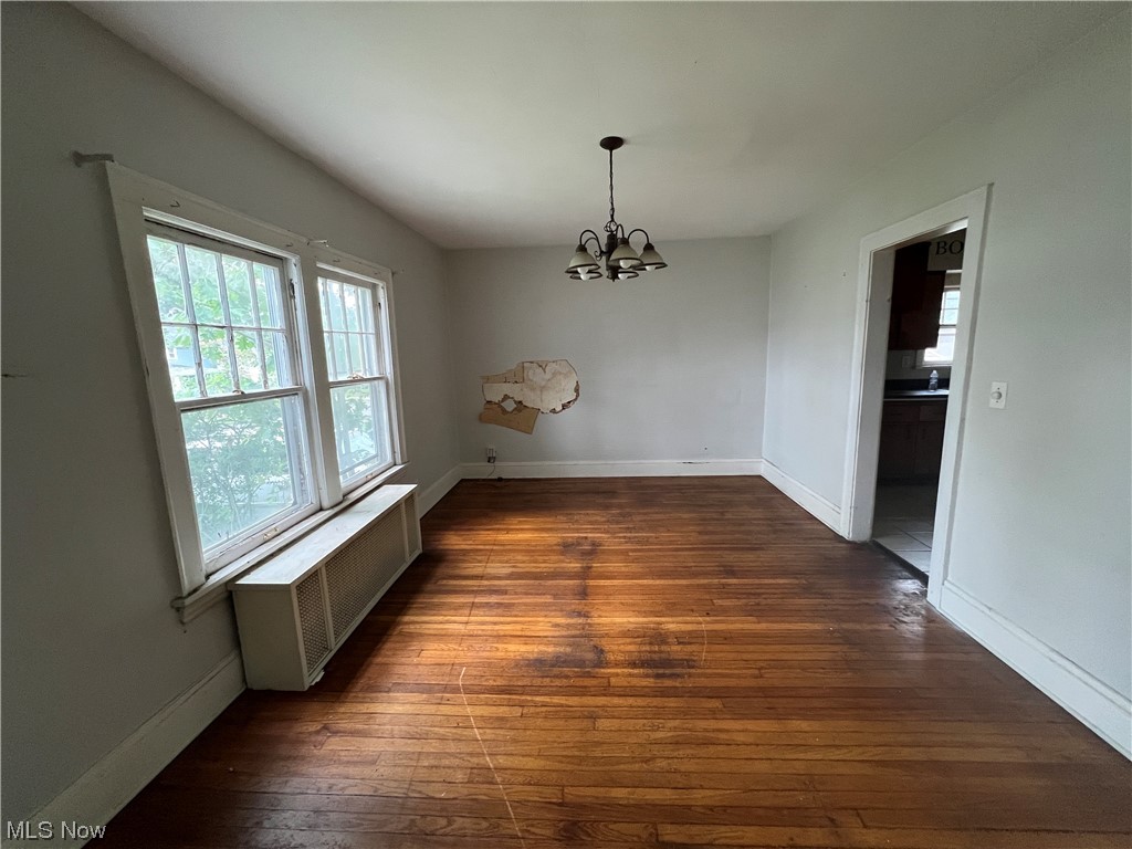 3169 Yorkshire Road Cleveland, OH 44118 - Photo 5 of 15 Spare room featuring dark hardwood flooring and radiator heating unit