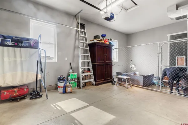 a living room with furniture gym equipment and a chandelier