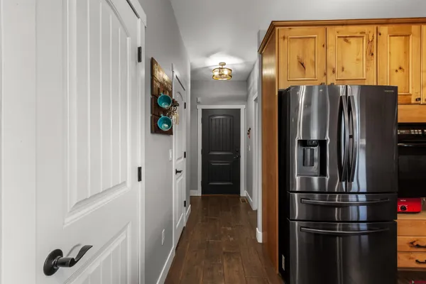 a view of a refrigerator in kitchen and wooden floor