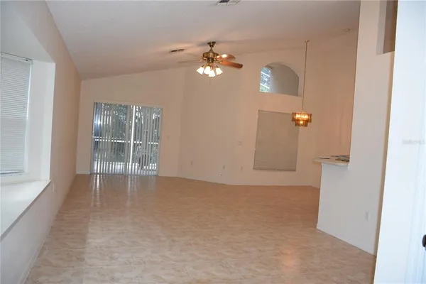 en empty room with windows and fireplace