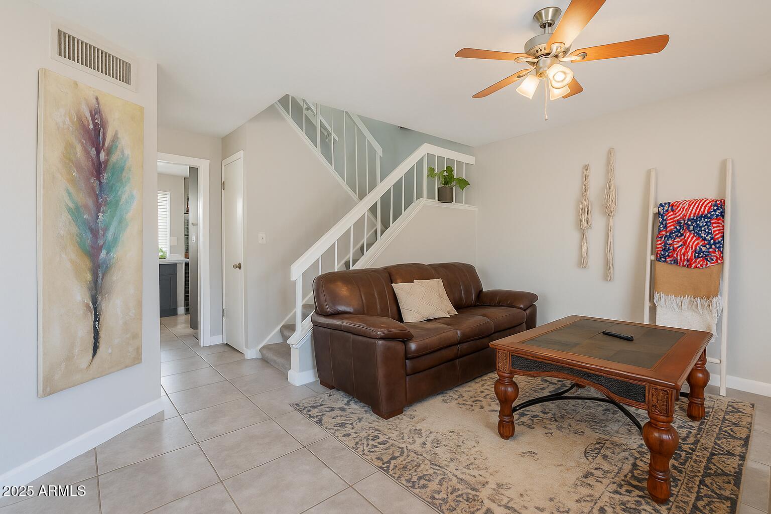 2455 East Broadway Road, Unit 115 Mesa, AZ 85204 - Photo 14 of 17 a living room with furniture and a ceiling fan