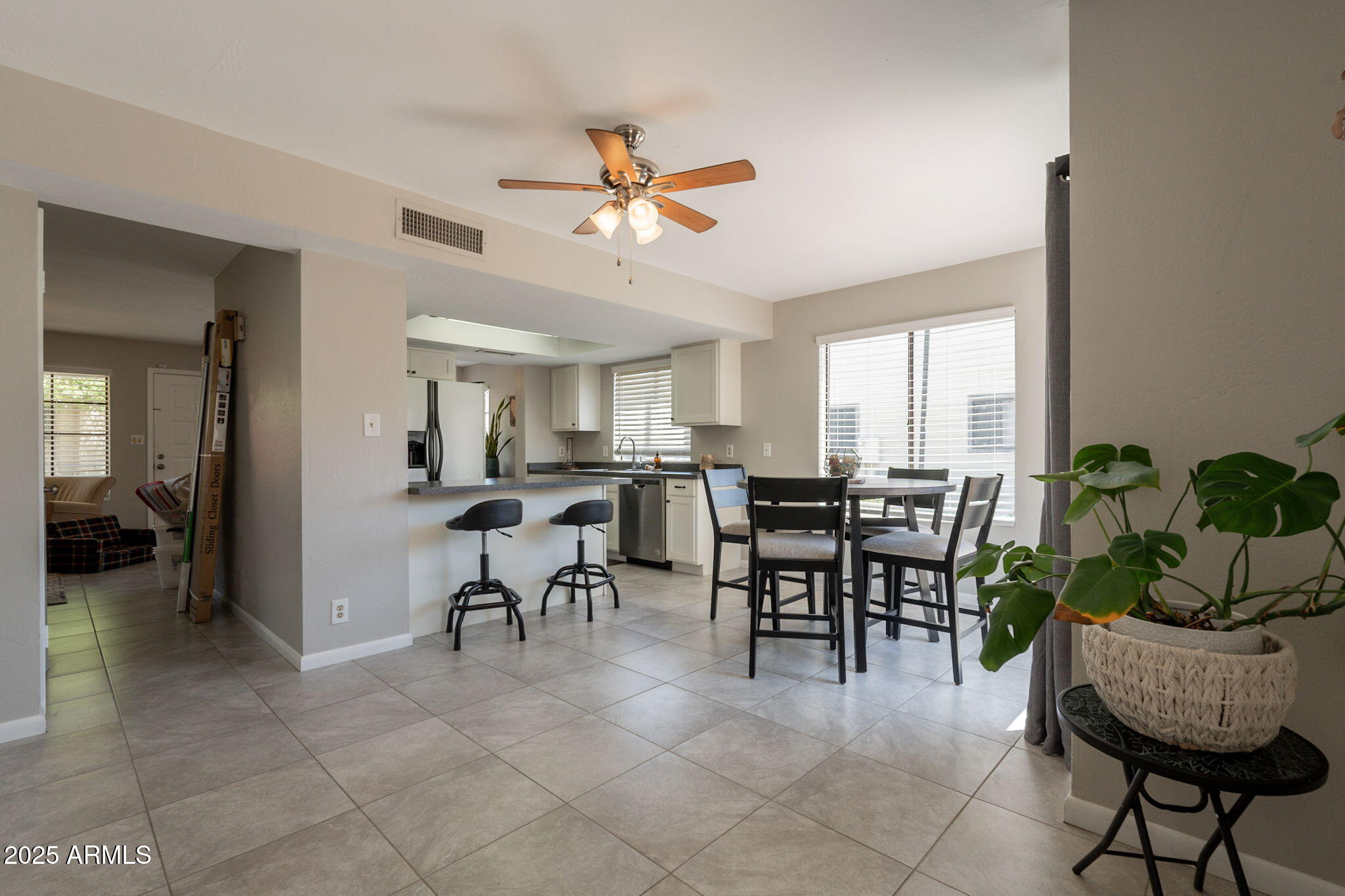 2455 East Broadway Road, Unit 115 Mesa, AZ 85204 - Photo 8 of 17 a view of a dining room and livingroom furniture a rug a chandelier and a painting
