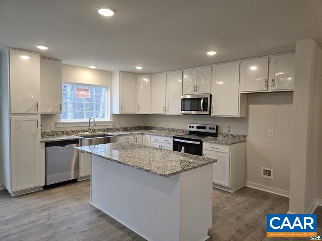 115 Bacon Bit Lane Louisa, VA 23093 - Photo 11 of 29 a kitchen with granite countertop stainless steel appliances a stove a sink a microwave a refrigerator and cabinets