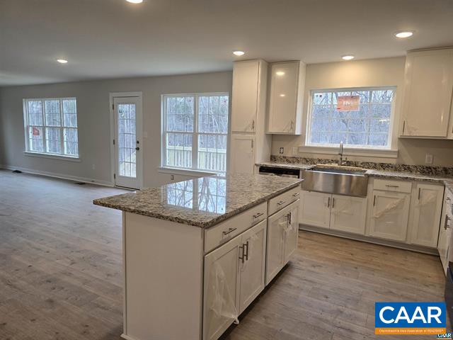 115 Bacon Bit Lane Louisa, VA 23093 - Photo 12 of 29 a kitchen with granite countertop kitchen island white cabinets and stainless steel appliances