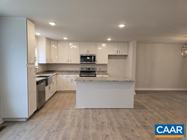 115 Bacon Bit Lane Louisa, VA 23093 - Photo 13 of 29 a kitchen with granite countertop white cabinets and white appliances