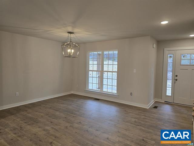 115 Bacon Bit Lane Louisa, VA 23093 - Photo 9 of 29 an empty room with wooden floor and windows