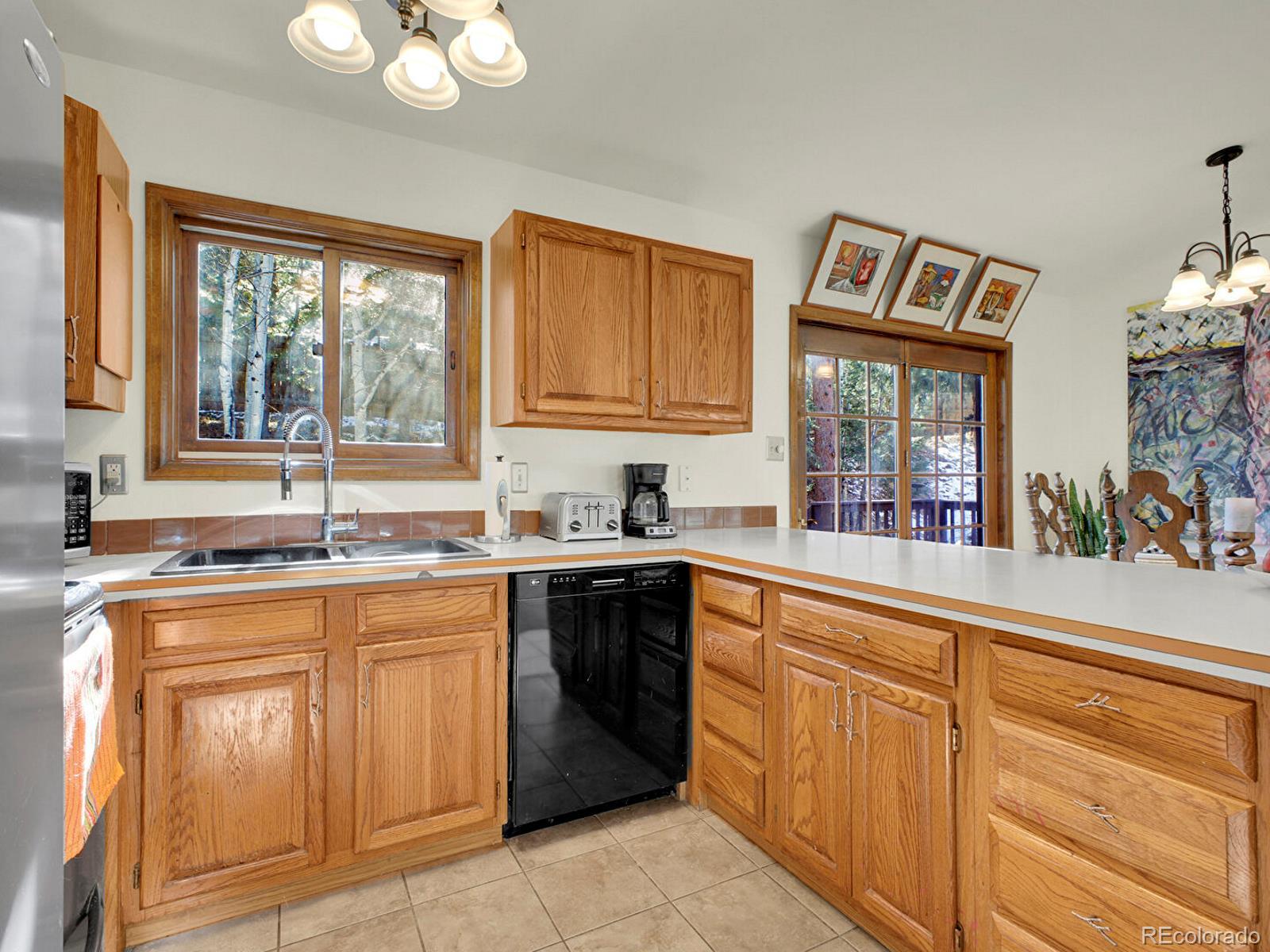 638 Impala Trail Bailey, CO 80421 - Photo 14 of 50 a kitchen with a sink and cabinets