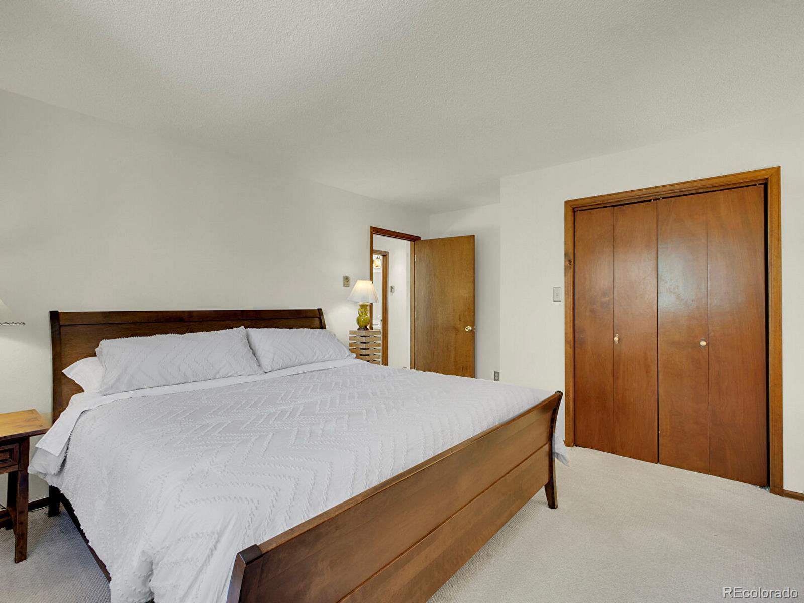 638 Impala Trail Bailey, CO 80421 - Photo 17 of 50 a bed room with a bed and a night stand