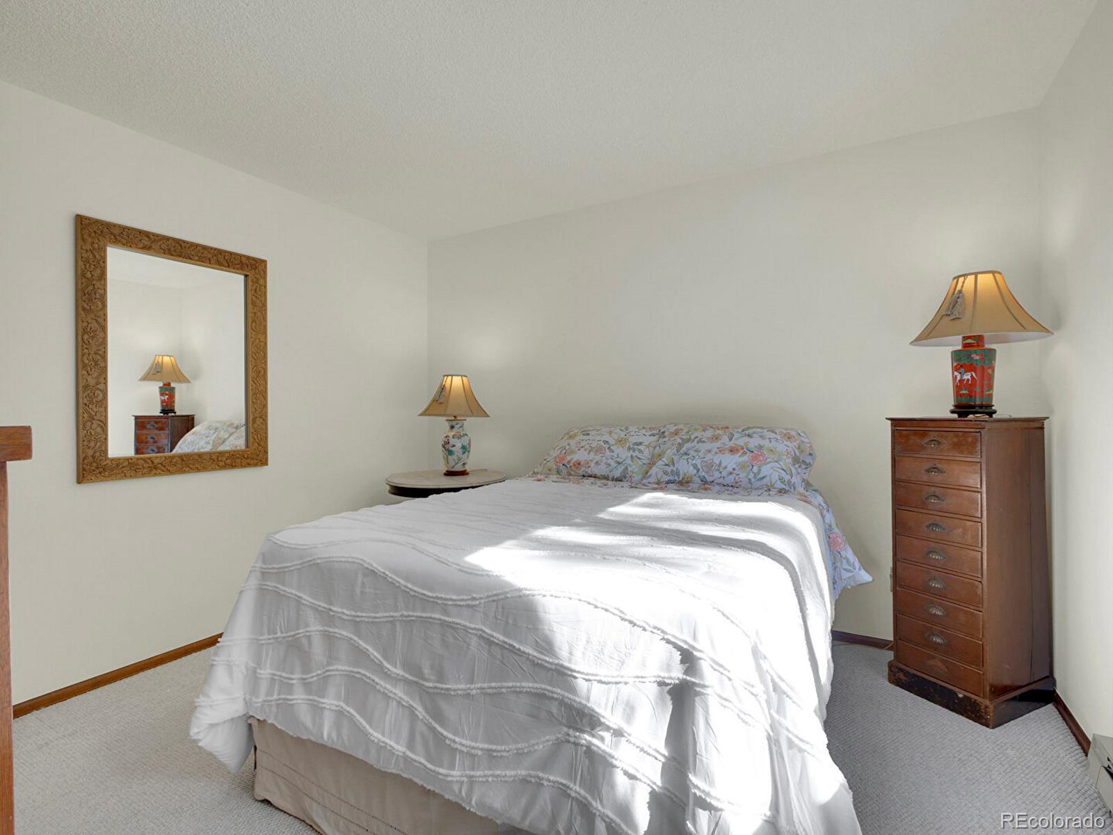 638 Impala Trail Bailey, CO 80421 - Photo 21 of 50 a bedroom with a bed and wooden floor