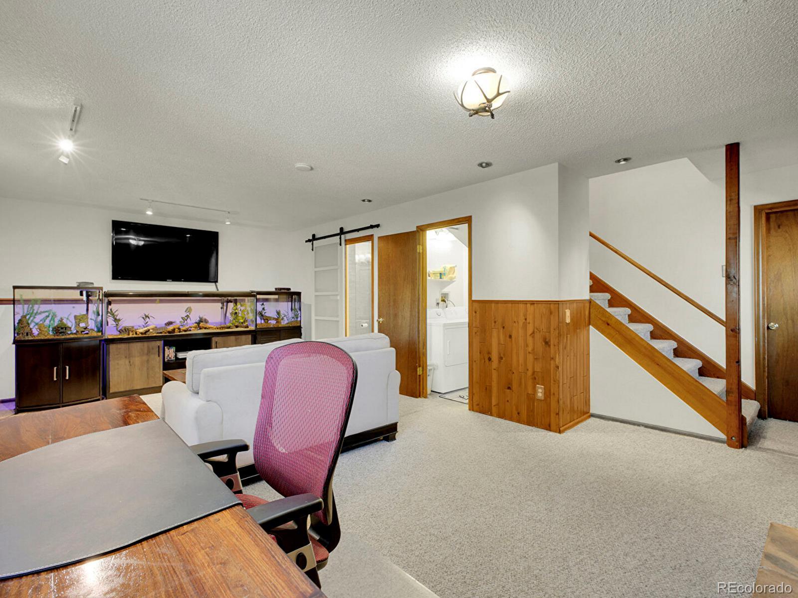638 Impala Trail Bailey, CO 80421 - Photo 24 of 50 a living room with furniture and a flat screen tv