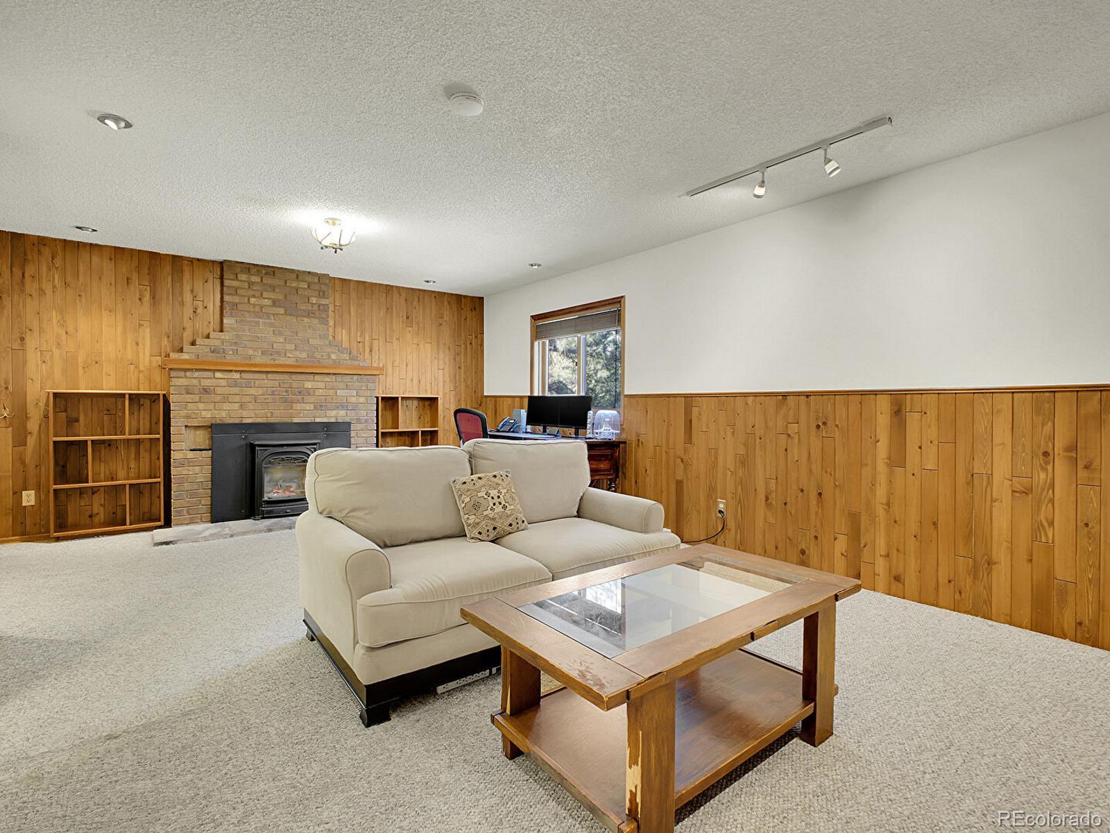 638 Impala Trail Bailey, CO 80421 - Photo 27 of 50 a living room with furniture and a fireplace