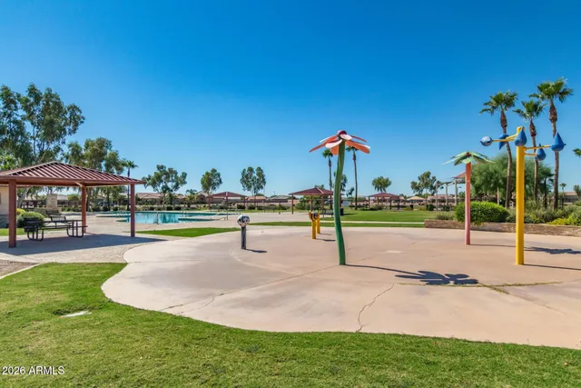 a view of swimming pool with chairs and tables