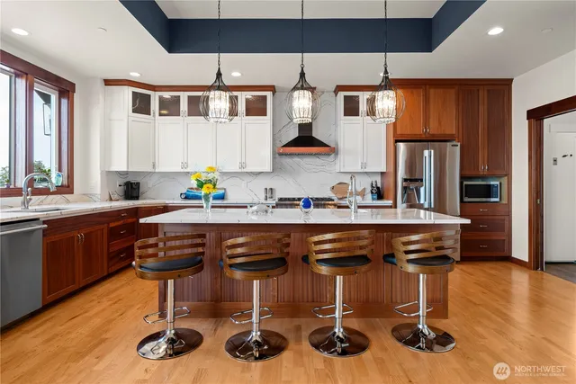 a view of a balcony with chairs and wooden floor
