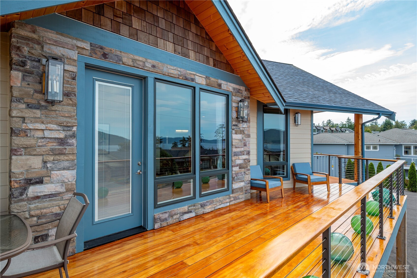 3803 West 2nd Street Anacortes, WA 98221 - Photo 23 of 40 a view of a balcony with chairs and wooden floor