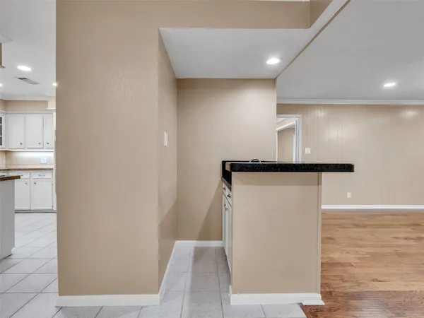 an empty room with windows fireplace and wooden floor