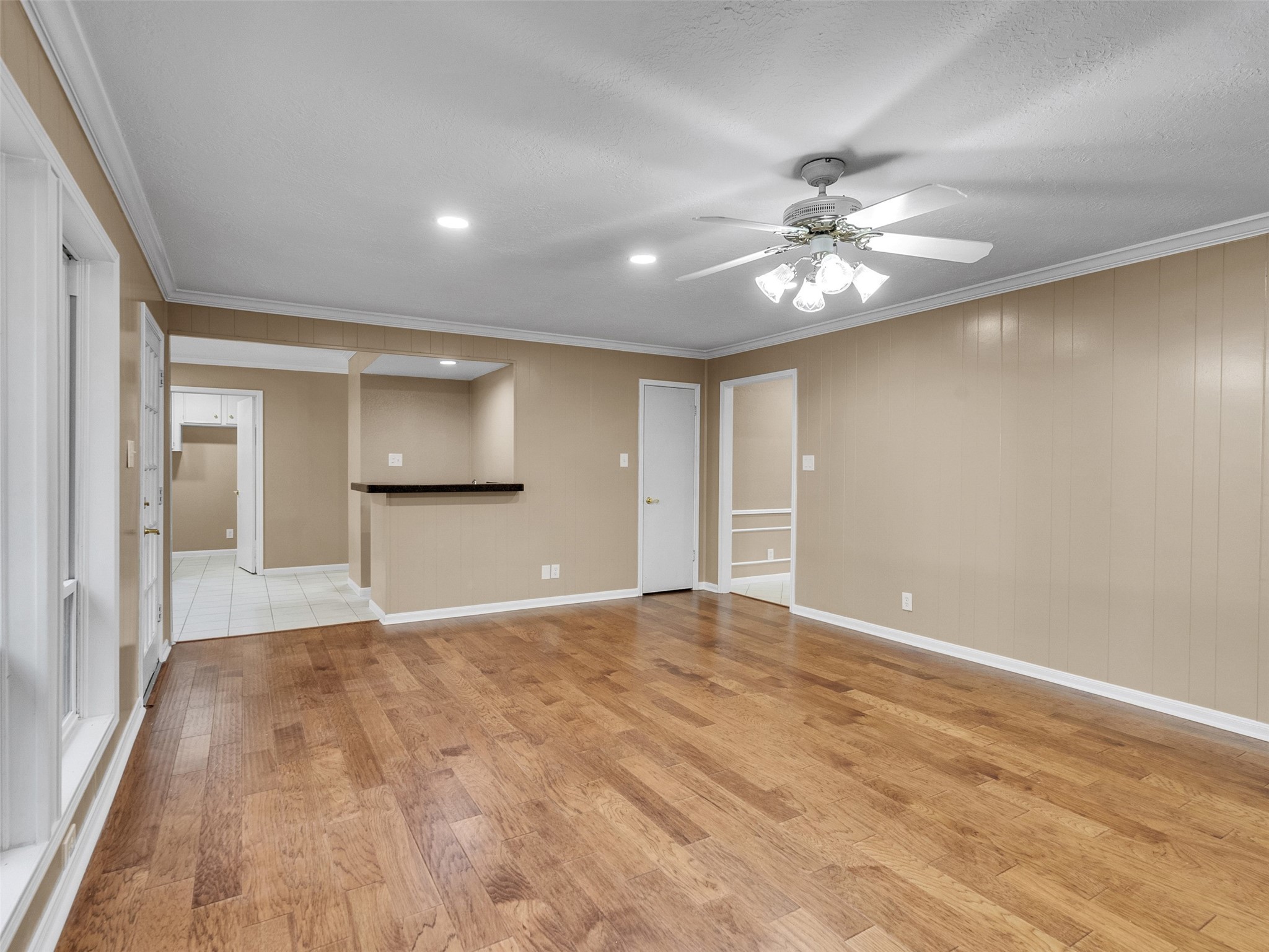 6702 Moccasin Bend Drive Spring, TX 77379 - Photo 19 of 35 a view of a big room with wooden floor and a chandelier fan