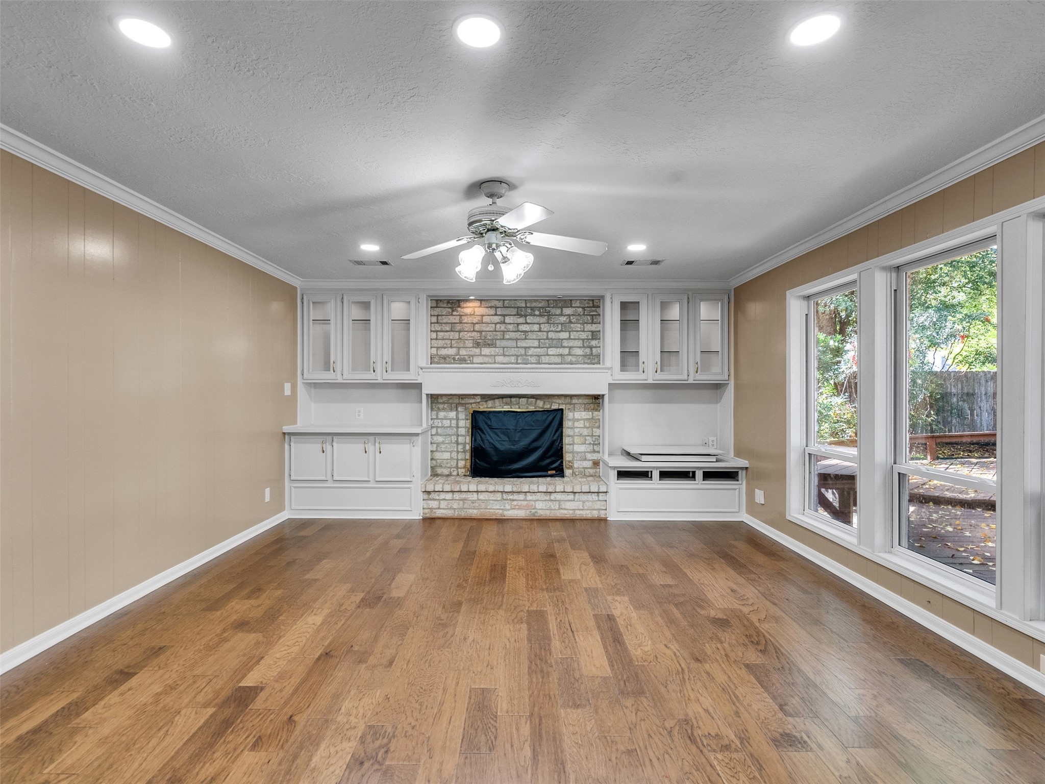6702 Moccasin Bend Drive Spring, TX 77379 - Photo 20 of 35 a view of an empty room with a fireplace and a window