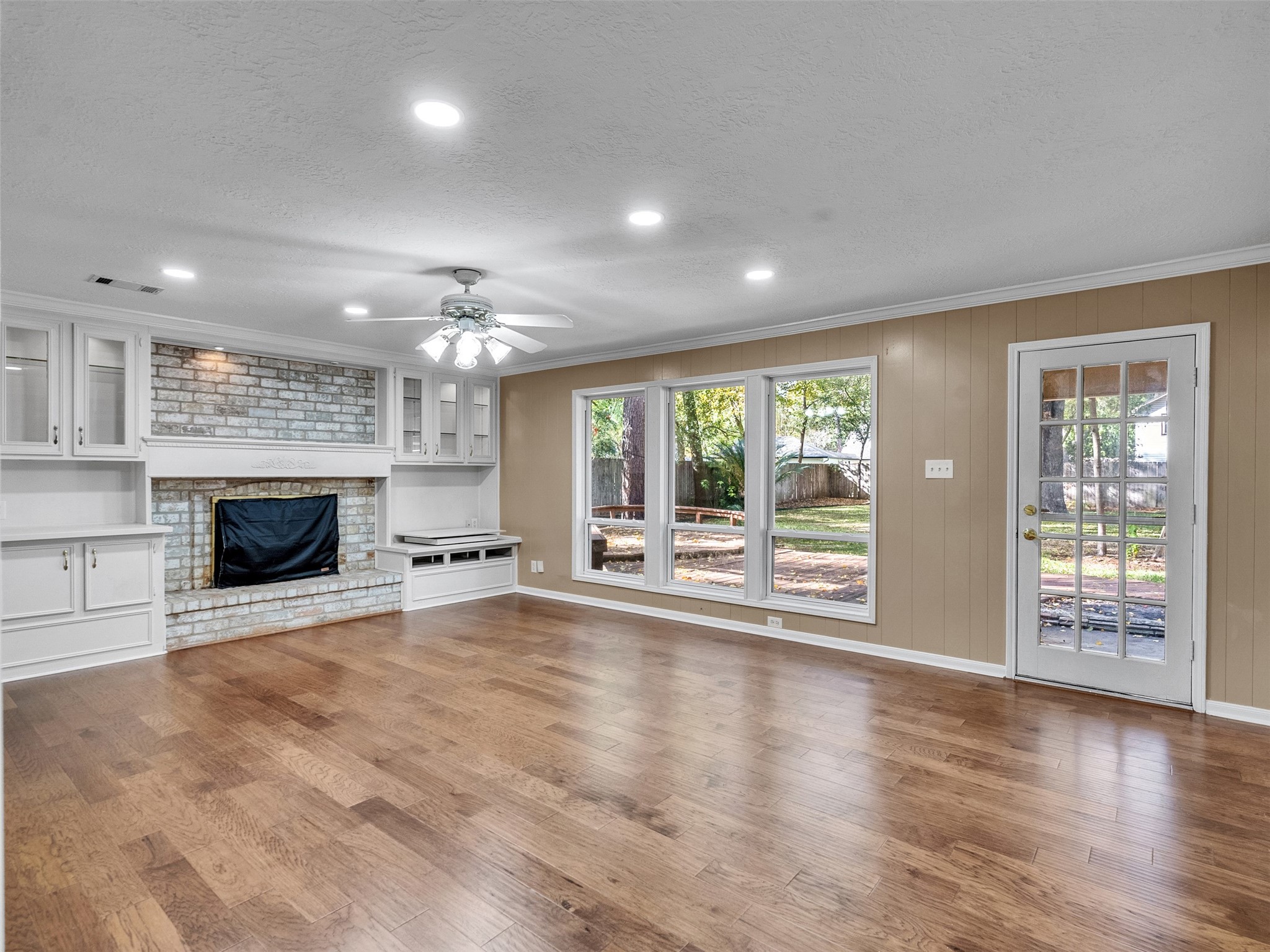 6702 Moccasin Bend Drive Spring, TX 77379 - Photo 21 of 35 an empty room with windows fireplace and wooden floor