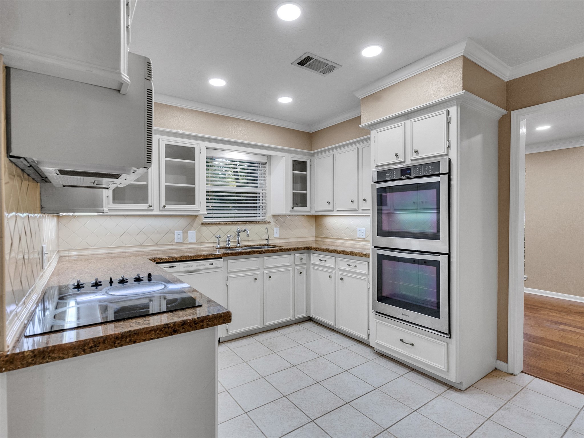 6702 Moccasin Bend Drive Spring, TX 77379 - Photo 10 of 35 a kitchen with stainless steel appliances granite countertop a sink and stove top oven