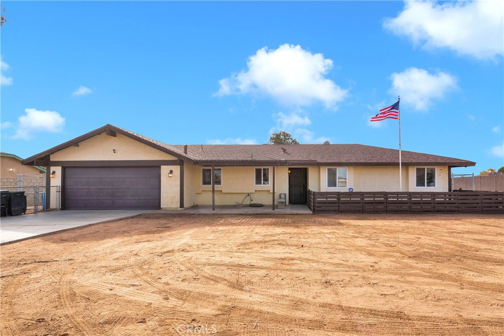 22749 Shawnee Road Apple Valley, CA 92308 - Photo 1 of 1 a front view of a house with a yard