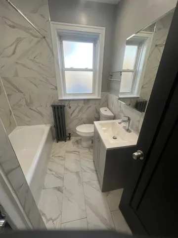 a bathroom with a sink a bathtub and window