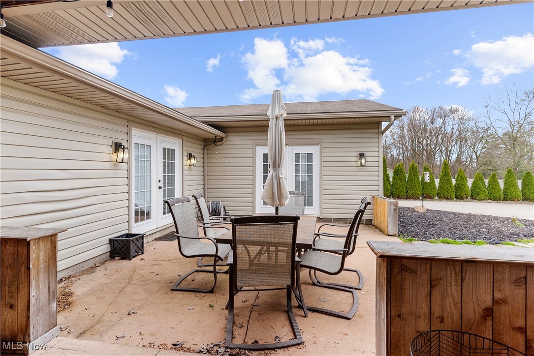 4075 Kirk Road Austintown, OH 44511 - Photo 8 of 40 View of patio / terrace featuring outdoor dining space and french doors