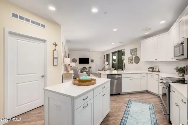a kitchen with a sink a stove and cabinets