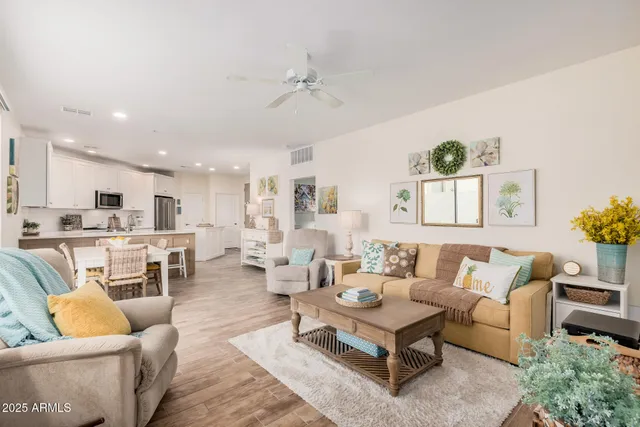 a living room with furniture kitchen view and a table