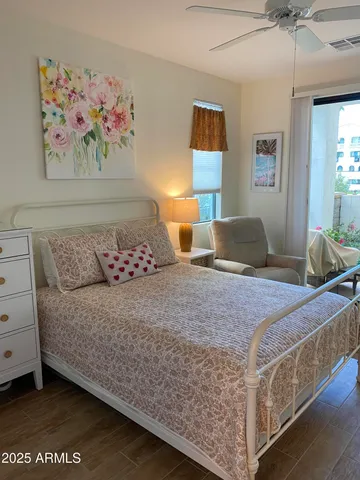 a bedroom with a bed and a painting on the wall