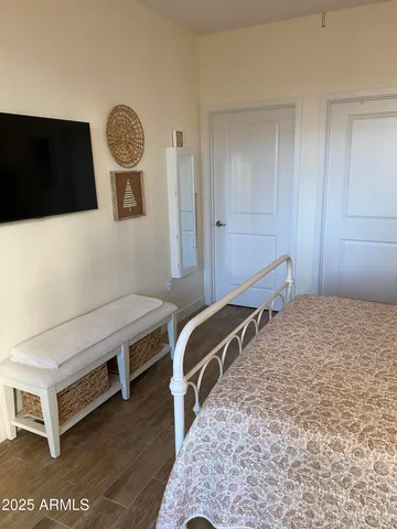 a bedroom with a bed and a flat screen tv
