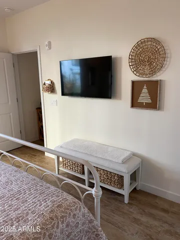 a view of an empty room with wooden floor and cabinet