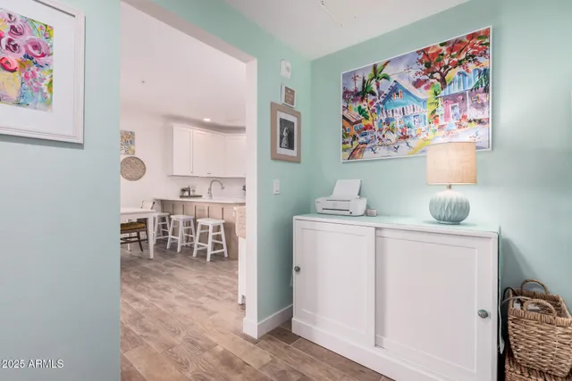 a room with furniture a rug and a painting on the wall