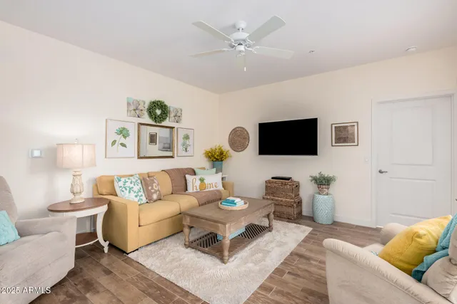 a living room with furniture a flat screen tv and view of kitchen