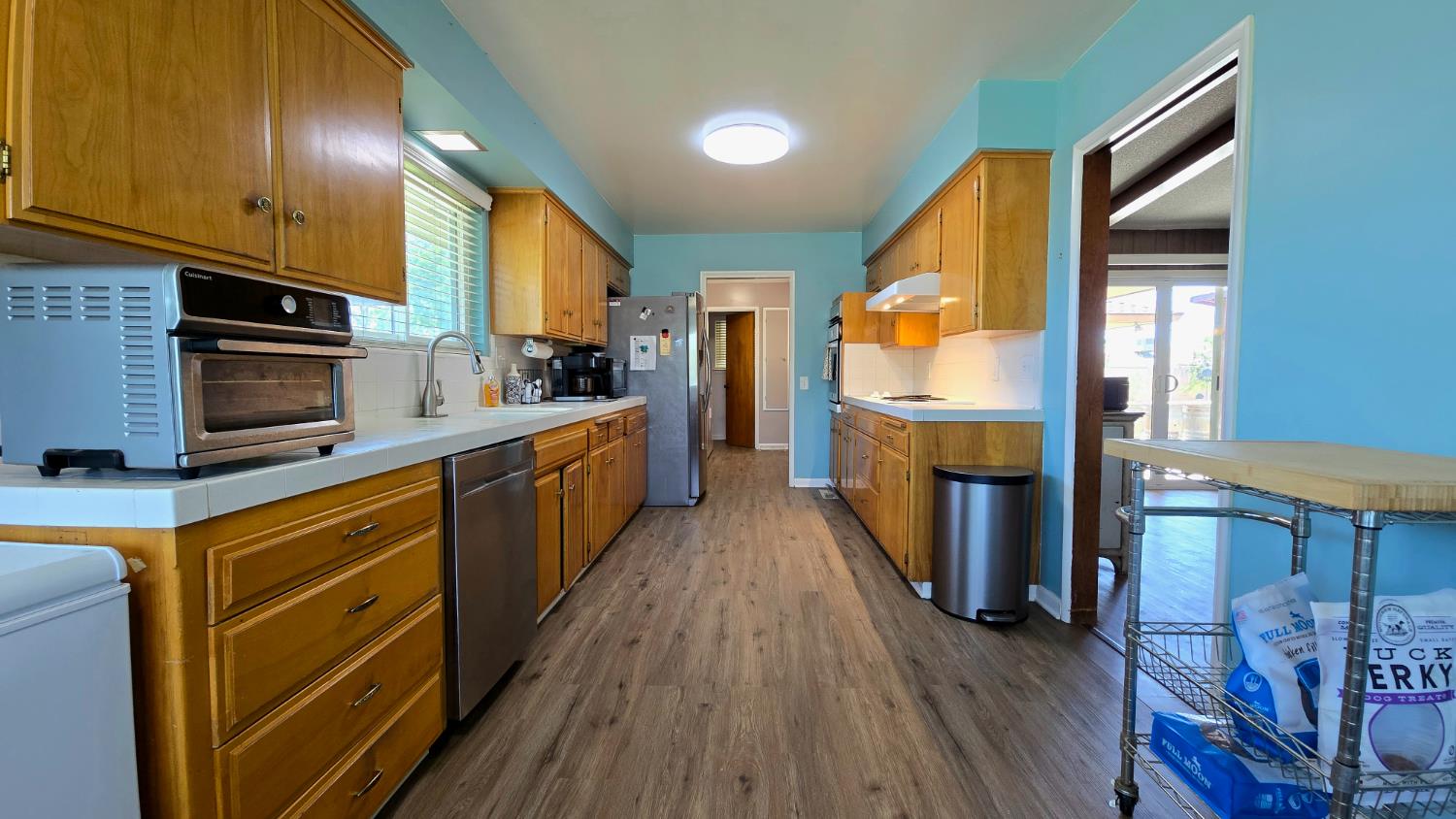 1205 Pine Street Selma, CA 93662 - Photo 20 of 41 a kitchen with stainless steel appliances a stove top oven a sink and a refrigerator