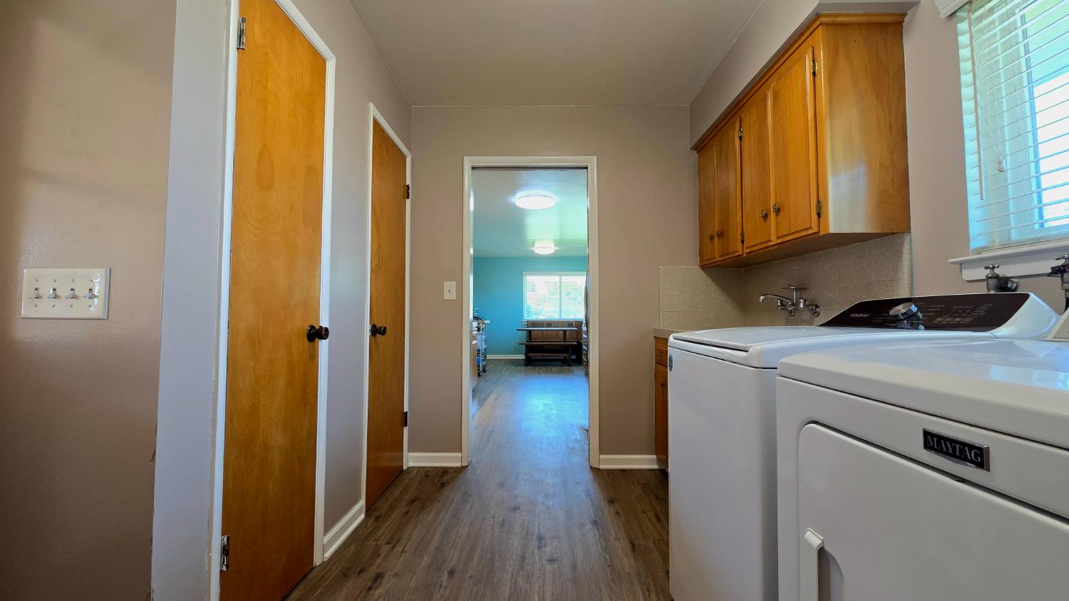 1205 Pine Street Selma, CA 93662 - Photo 22 of 41 a view of hallway with livingroom and wooden floor
