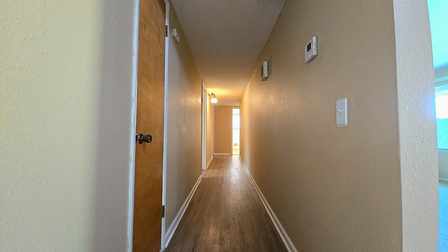 1205 Pine Street Selma, CA 93662 - Photo 26 of 41 a view of a hallway with wooden floor