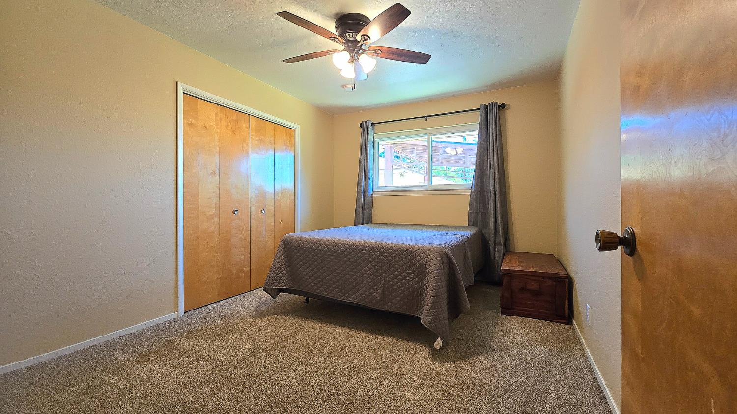 1205 Pine Street Selma, CA 93662 - Photo 27 of 41 a bedroom with a bed and a chandelier