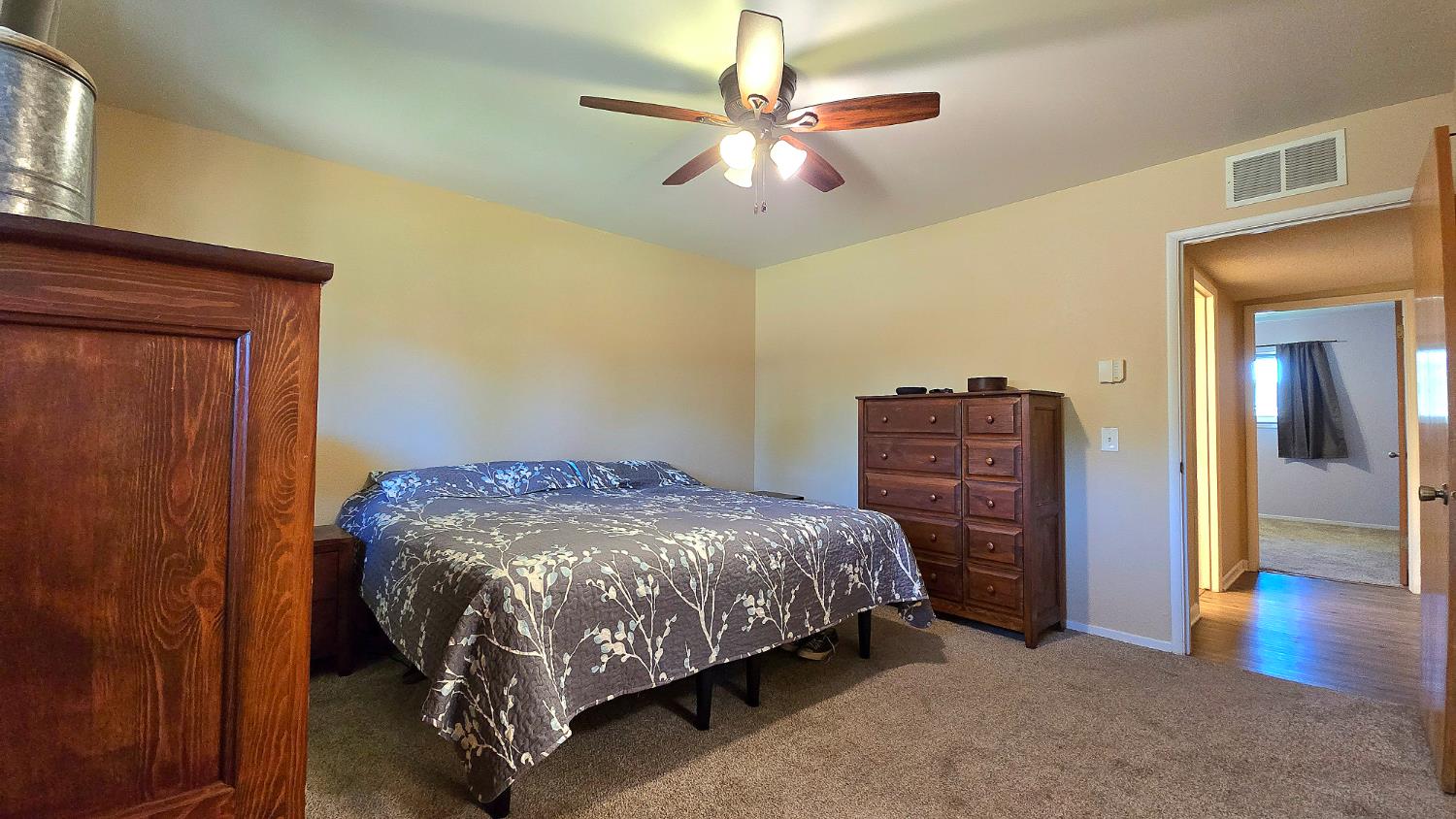 1205 Pine Street Selma, CA 93662 - Photo 28 of 41 a bed sitting in a bedroom next to a window and a chandelier
