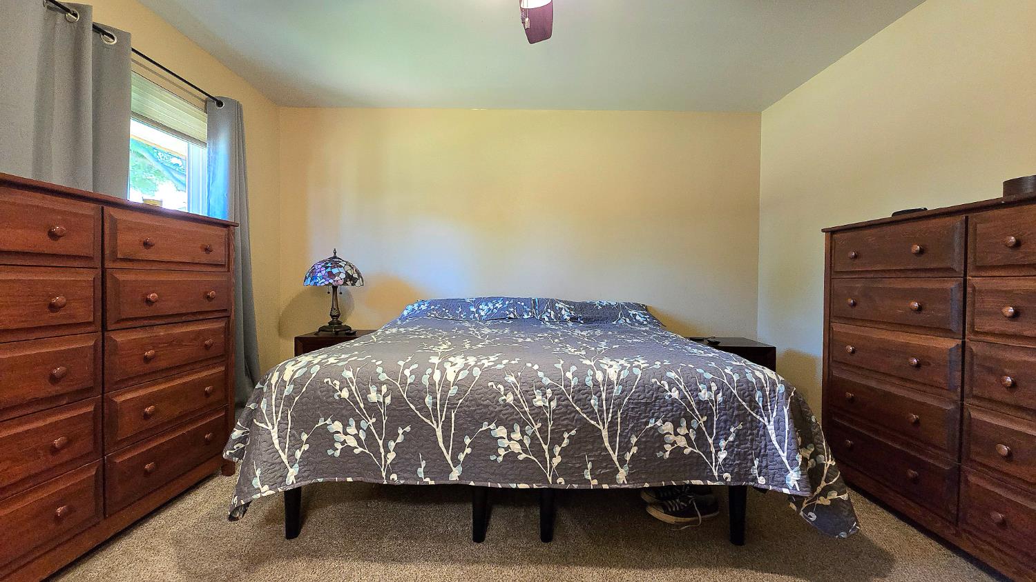 1205 Pine Street Selma, CA 93662 - Photo 29 of 41 a bed sitting in a bedroom next to a window and dresser