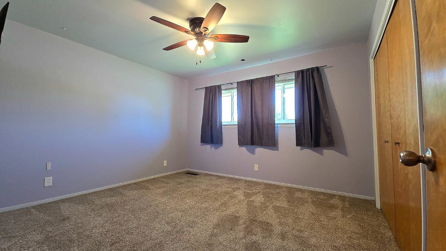 1205 Pine Street Selma, CA 93662 - Photo 32 of 41 an empty room with chandelier fan and windows