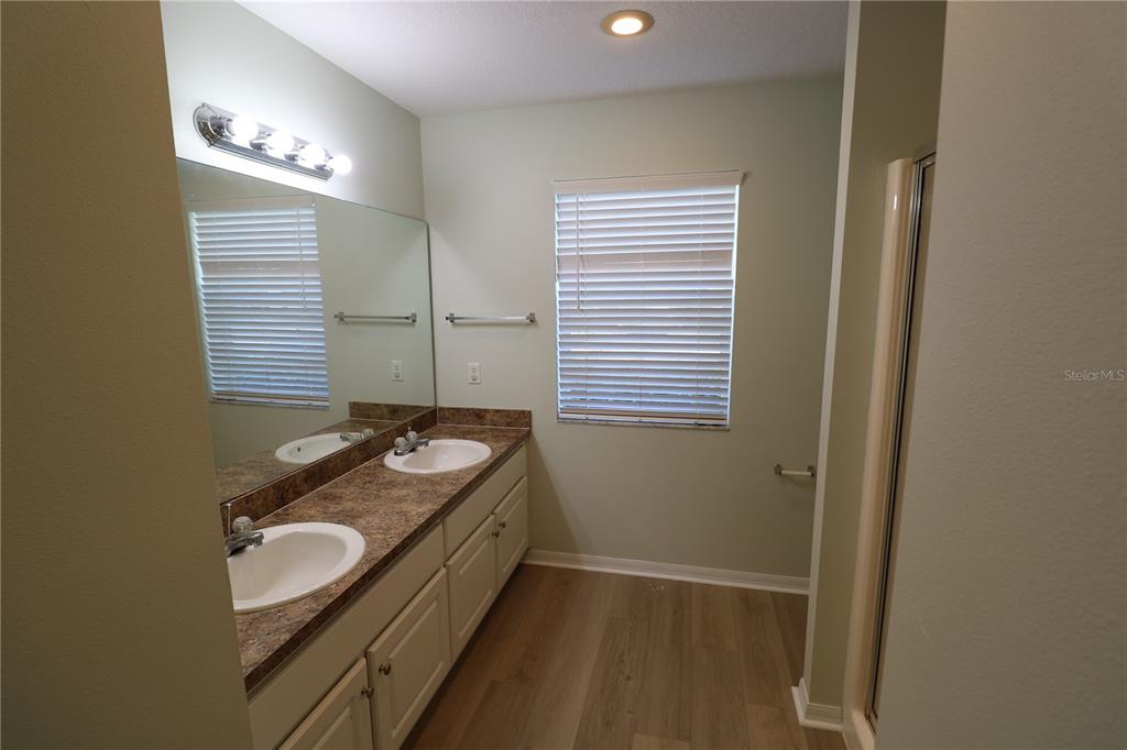 6750 Moonglow Drive, Unit 102 Port Richey, FL 34668 - Photo 14 of 26 a bathroom with a granite countertop sink and a mirror